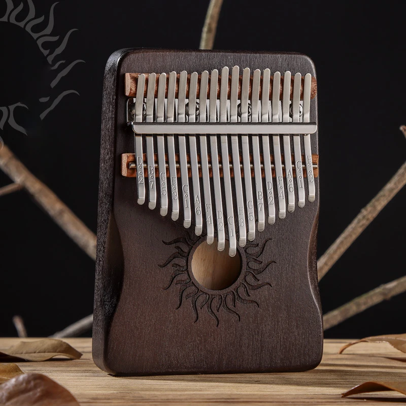 Sbe52f21bd4234105bff32791d56f3168W.webp Kalimba 17 blades in maple wood - Dark brown - Sun motif